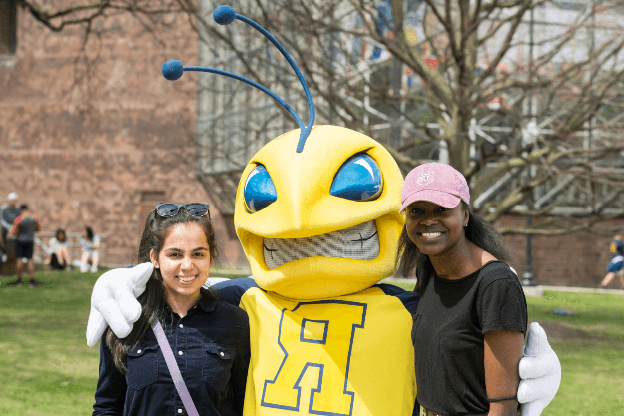 University of Rochester mascot, Rocky, with two students